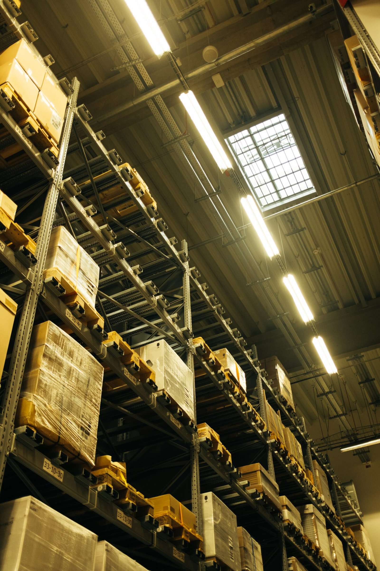 Tall warehouse shelving stacked with boxed packages
